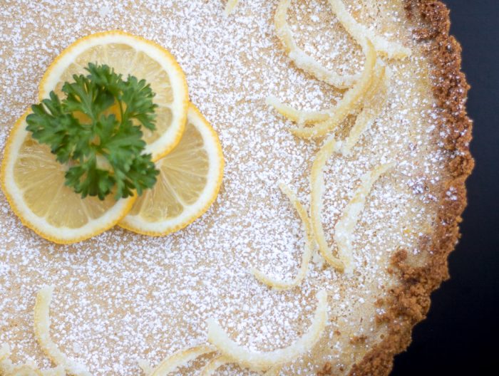 creamy lemon tart with pistachio cardamom crust from above