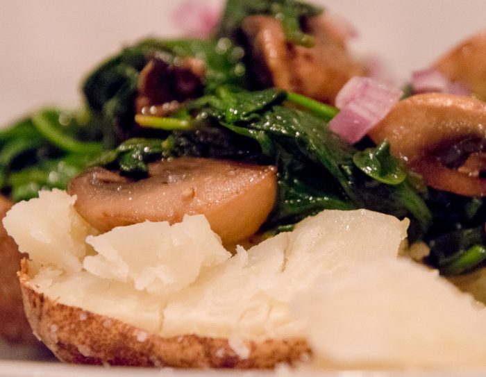 spinach and mushrooms on a baked potato