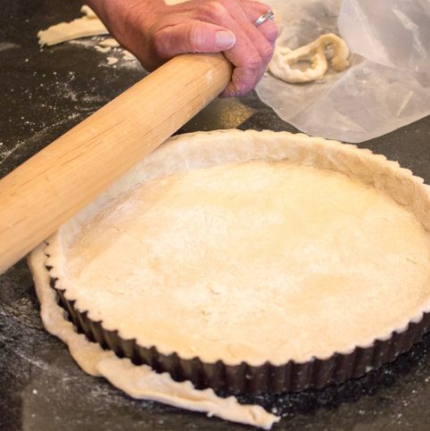 Tart Crust being rolled into a tart pan