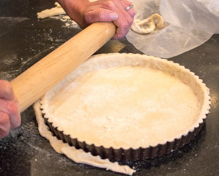 Tart Crust being rolled into a tart pan