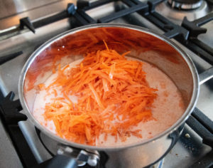 Grated carrots cooking in milk