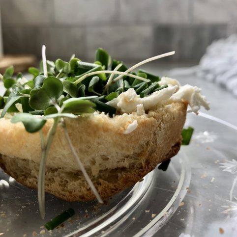 English muffin with cream cheese, garden chives, and micro greens